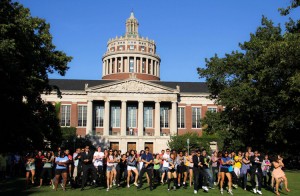 Infected Rochester students congregate on the Eastman Quadrangle in a flash mob, one of the more noticeable symptoms of “Gangnam Style” along with flailing and riding what appears to be an invisible horse. Students are advised to take caution.
