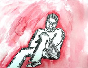 Daniel Caesar sitting in a sweater, chilling